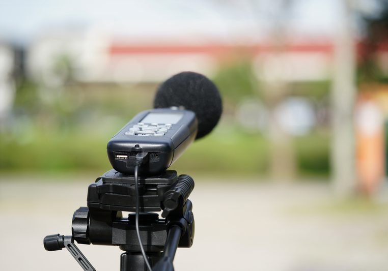 Measuring the noise on the road with a sound level meter.